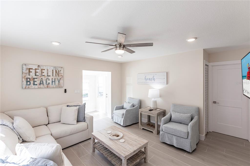 6020 Midnight Pass Road, Unit 15 Sarasota, FL 34242 - Photo 4 of 19 a living room with furniture and a ceiling fan