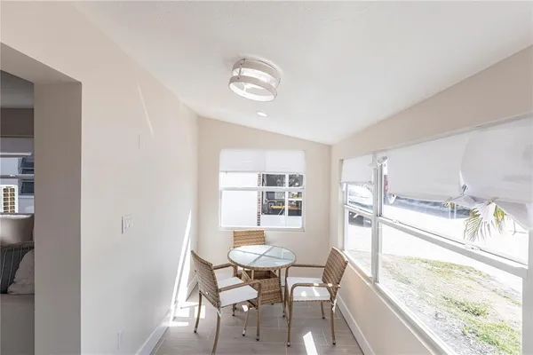 a view of a dining room with furniture and a large window