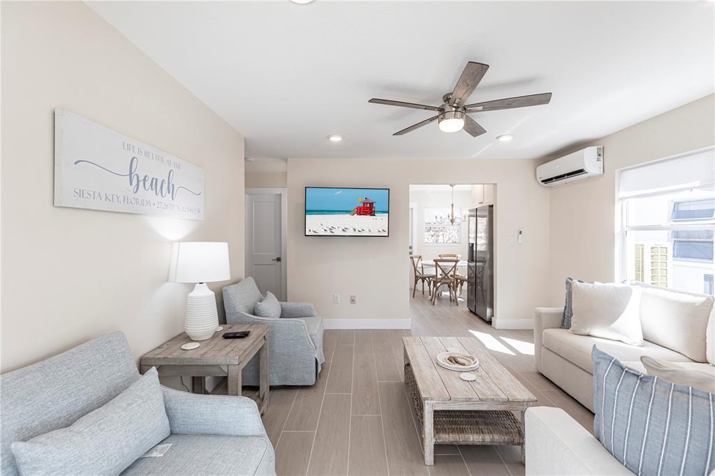 6020 Midnight Pass Road, Unit 15 Sarasota, FL 34242 - Photo 7 of 19 a living room with furniture and a large window