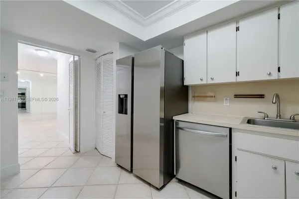 a kitchen with stainless steel appliances granite countertop a refrigerator and a sink