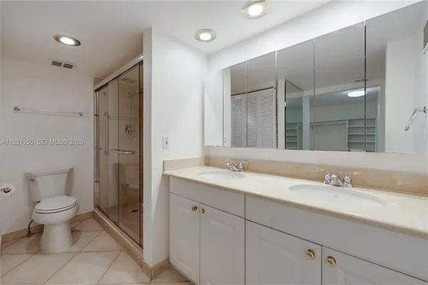 a spacious bathroom with a granite countertop sink toilet and shower