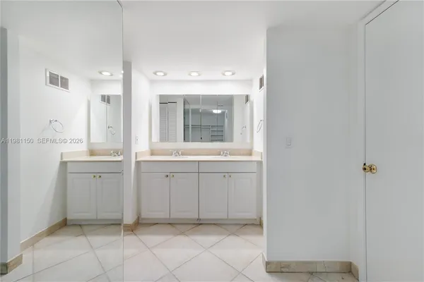 a spacious bathroom with a mirror sink and vanity