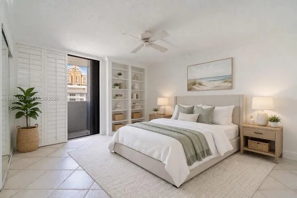 a bedroom with a large bed and potted plant