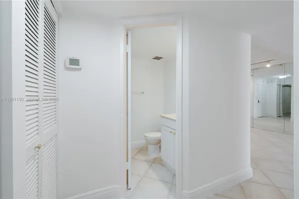 a bathroom with a granite countertop toilet and a shower
