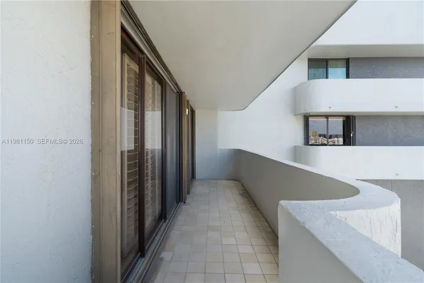 a kitchen with windows and refrigerator