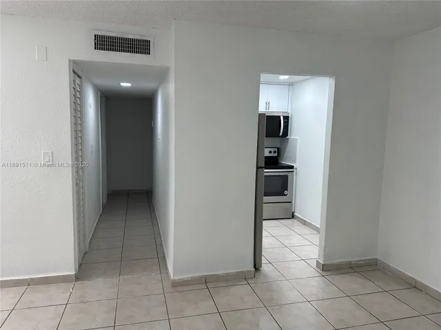 a view of a hallway to rooms and stairs