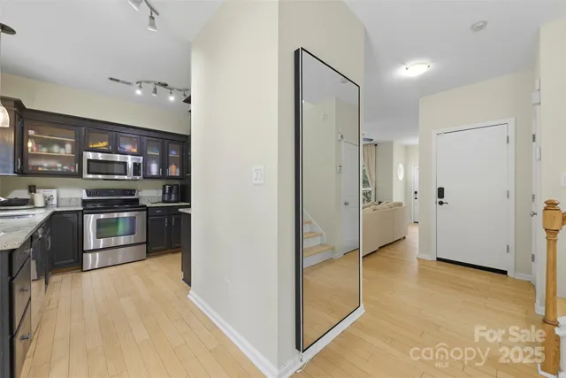a view of a kitchen with a refrigerator and a stove top oven