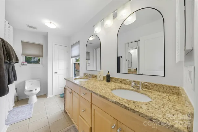 a spacious bathroom with a granite countertop sink and a mirror