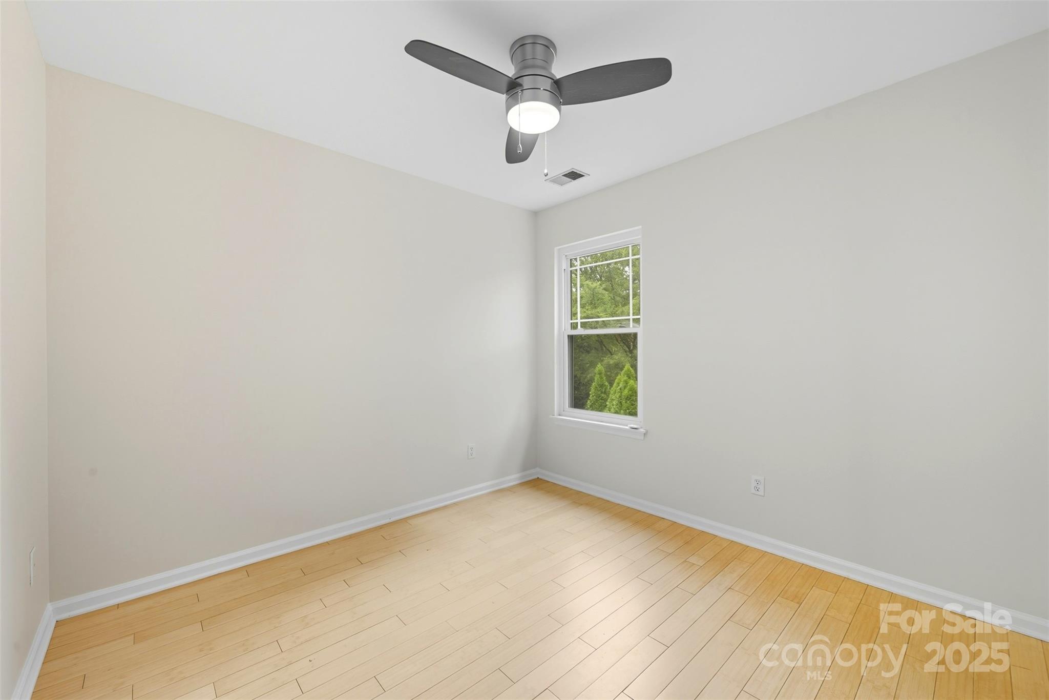 13308 Bolingbrook Lane Charlotte, NC 28273 - Photo 18 of 34 an empty room with a window and a ceiling fan