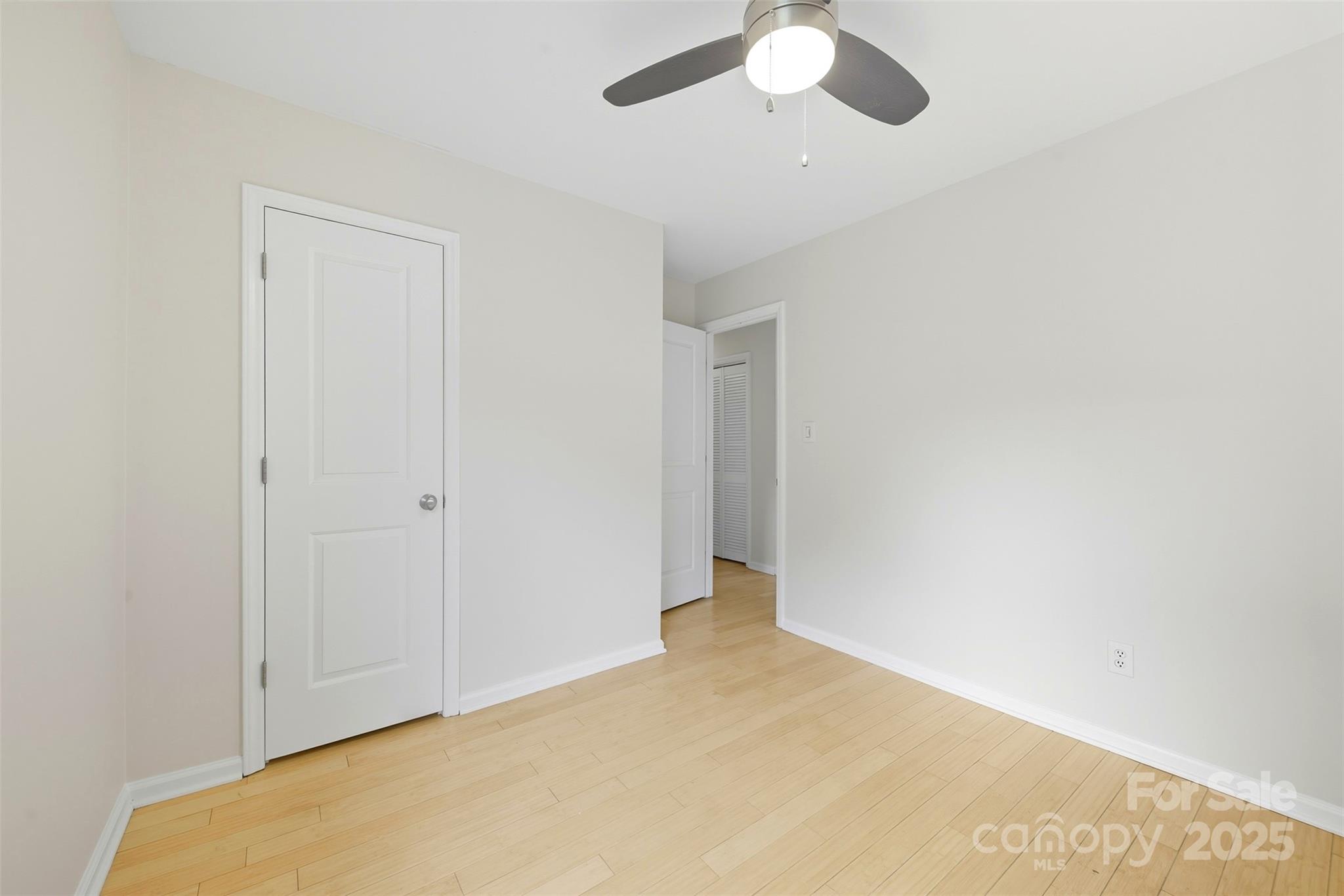 13308 Bolingbrook Lane Charlotte, NC 28273 - Photo 19 of 34 an empty room with a chandelier fan