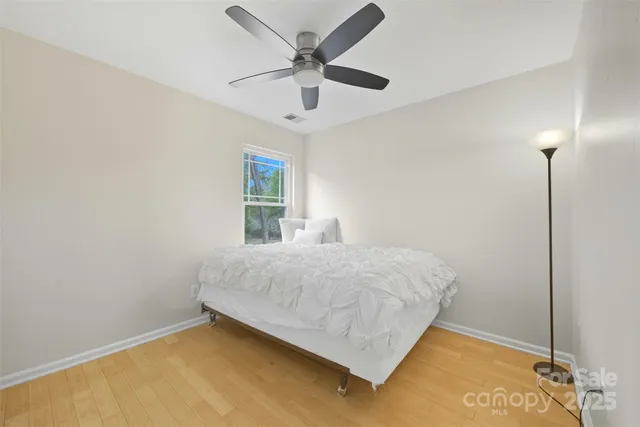 a bedroom with a bed and a ceiling fan