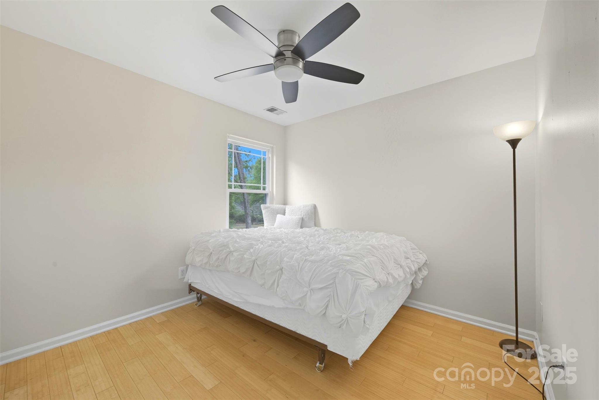 13308 Bolingbrook Lane Charlotte, NC 28273 - Photo 20 of 34 a bedroom with a bed and a ceiling fan