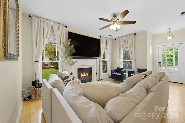 a living room with furniture a fireplace and a flat screen tv