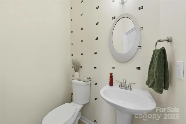 a white toilet sitting next to a bathroom sink