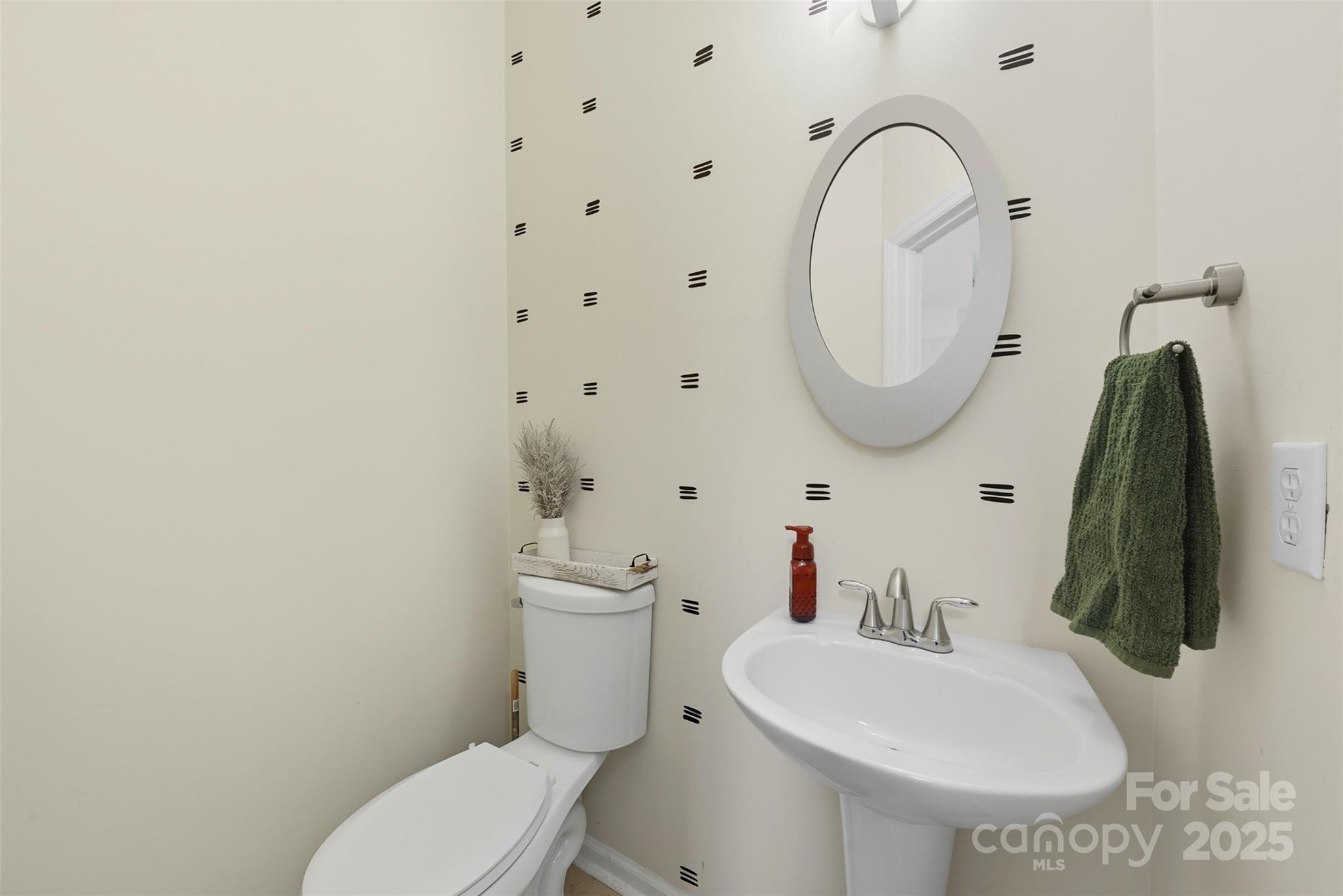 13308 Bolingbrook Lane Charlotte, NC 28273 - Photo 6 of 34 a white toilet sitting next to a bathroom sink