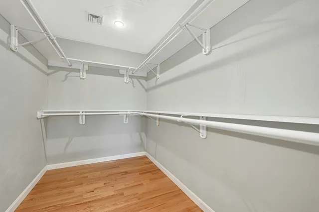 a view of a room with wooden floor