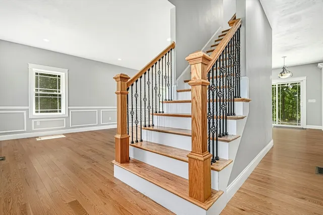 a view of entryway and hall with wooden floor