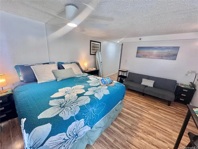 a living room with furniture rug and wooden floor