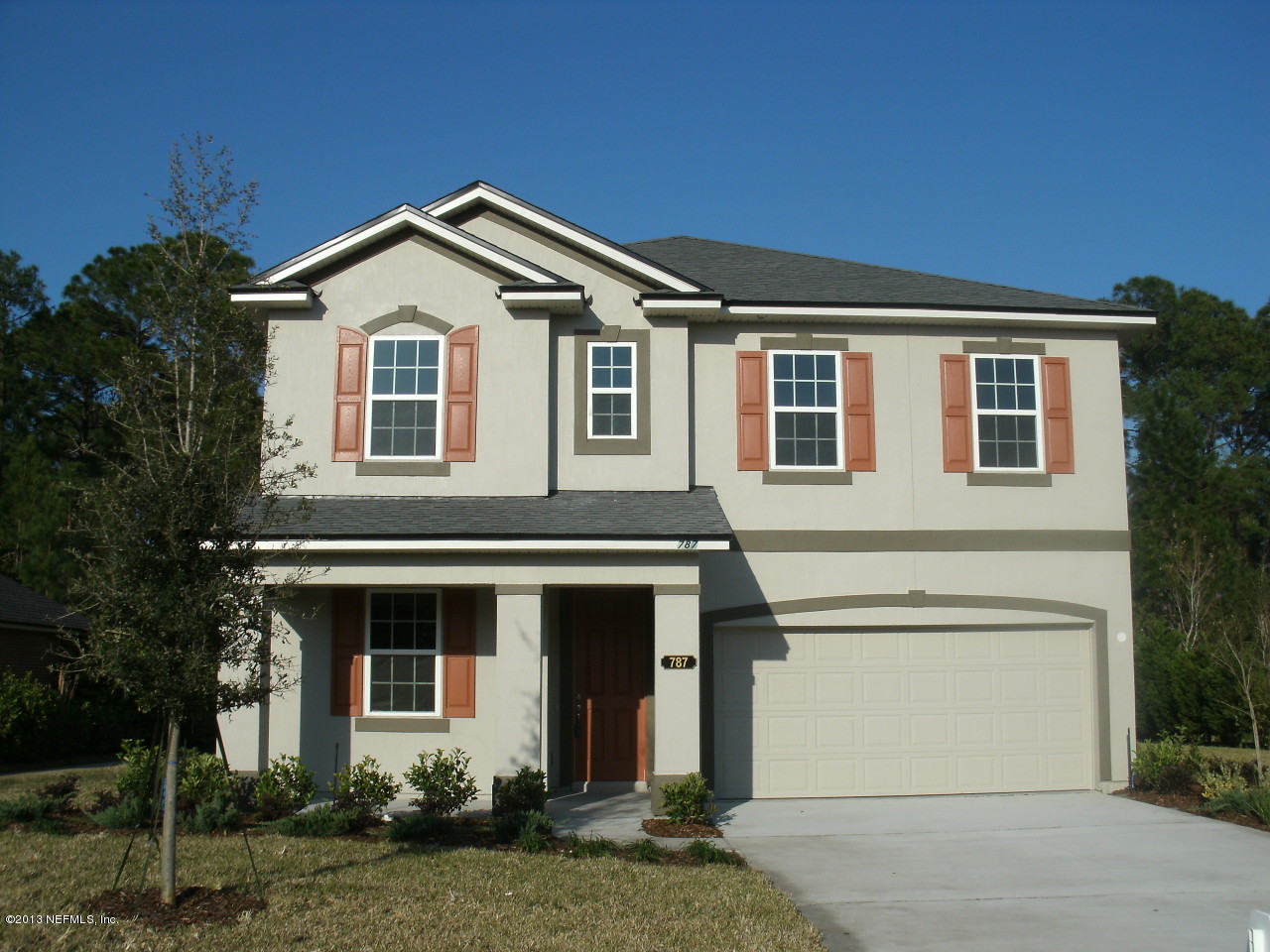 787 East Red House Branch Road St. Augustine, FL 32084 - Photo 1 of 29 a front view of a house with a yard and garage