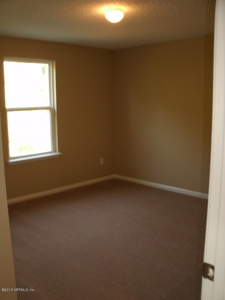 787 East Red House Branch Road St. Augustine, FL 32084 - Photo 26 of 29 a view of an empty room and a window