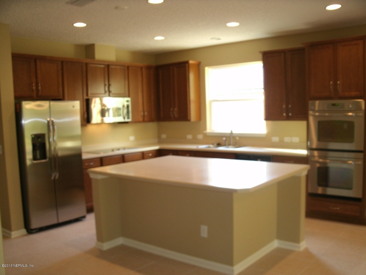 787 East Red House Branch Road St. Augustine, FL 32084 - Photo 10 of 29 a kitchen with kitchen island a counter top space cabinets stainless steel appliances and a window