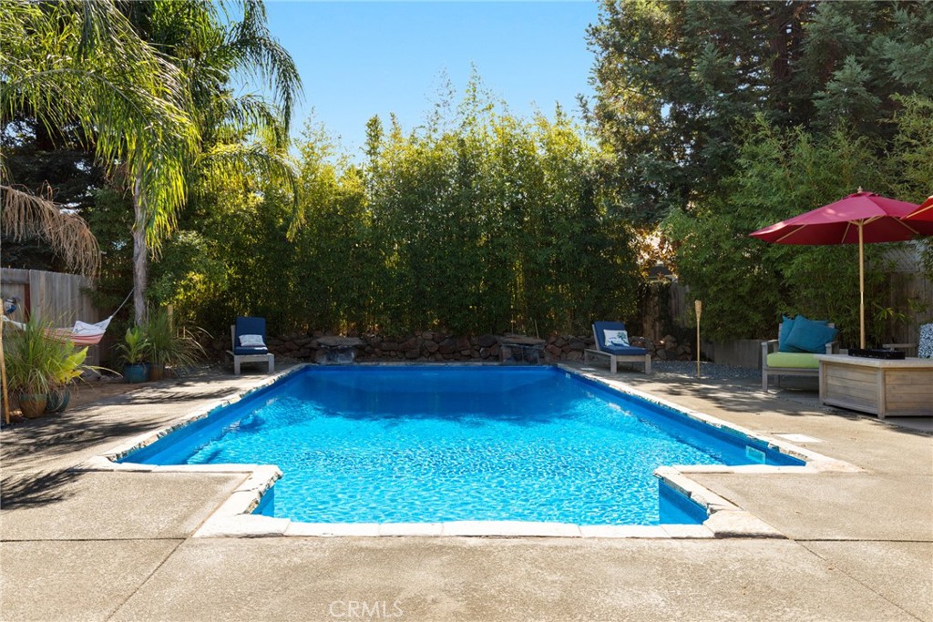 331 Weymouth Way Chico, CA 95973 - Photo 23 of 26 a view of pool with lawn chairs under an umbrella