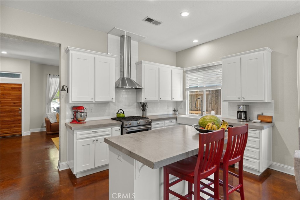 331 Weymouth Way Chico, CA 95973 - Photo 8 of 26 a kitchen with stainless steel appliances a white table chairs and a refrigerator