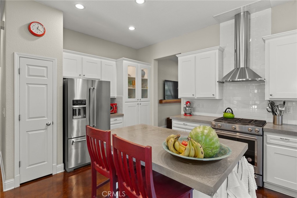 331 Weymouth Way Chico, CA 95973 - Photo 9 of 26 a kitchen with stainless steel appliances granite countertop a dining table chairs refrigerator and sink