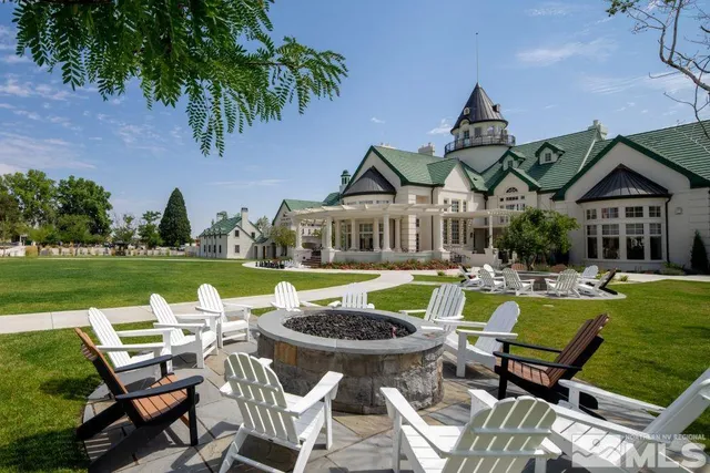a view of a house with swimming pool and chairs