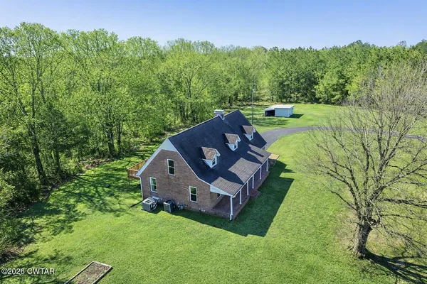 a view of a green field with lots of bushes