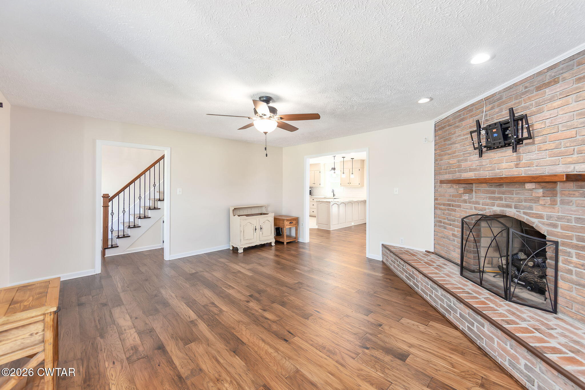 105 Center Hill-Wright Road Reagan, TN 38368 - Photo 6 of 54 a view of a livingroom with a fireplace wooden floor and staircase