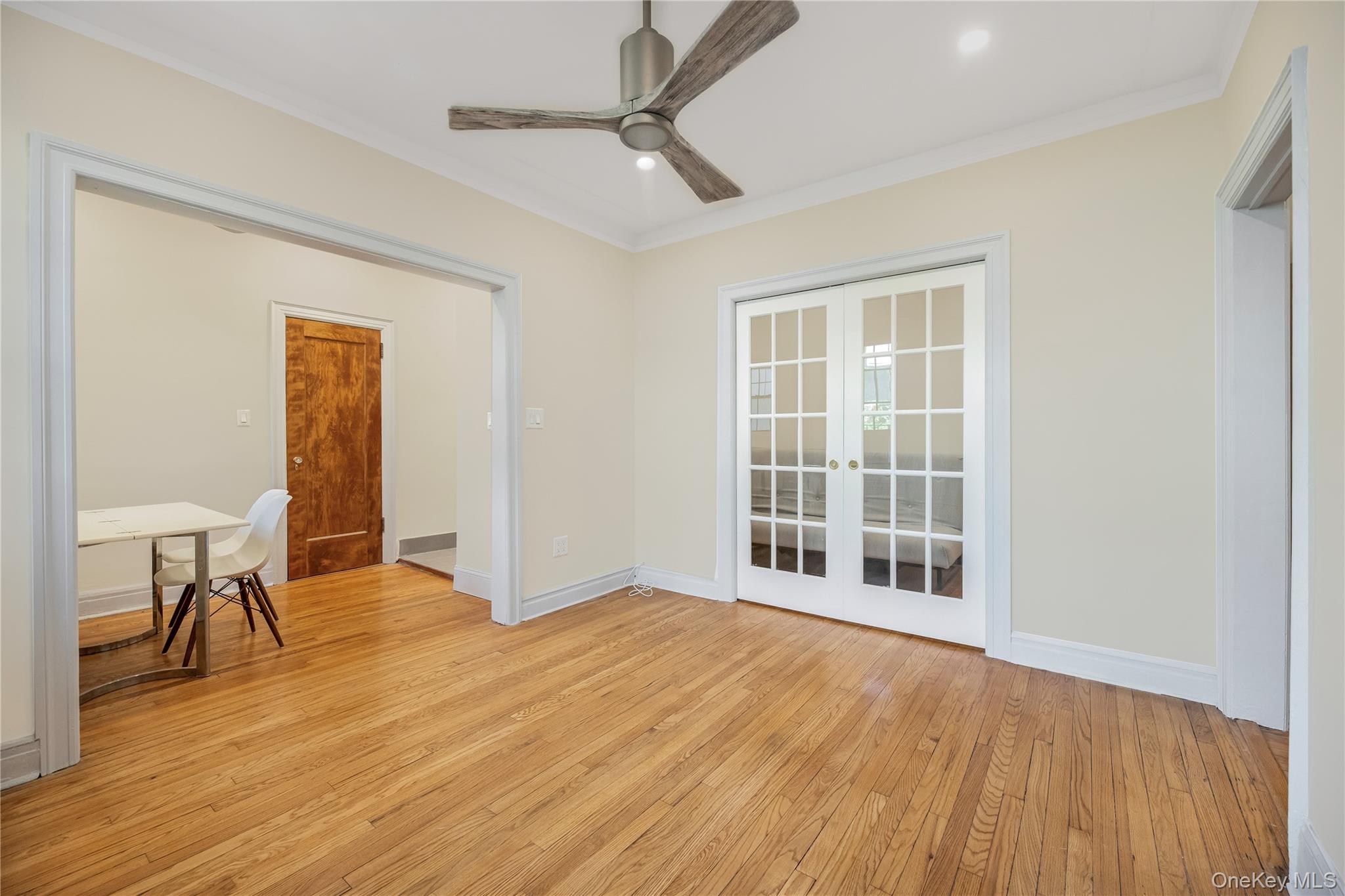 26 Pondfield Road, Unit 1D Bronxville, NY 10708 - Photo 13 of 21 a view of an empty room with a window and wooden floor