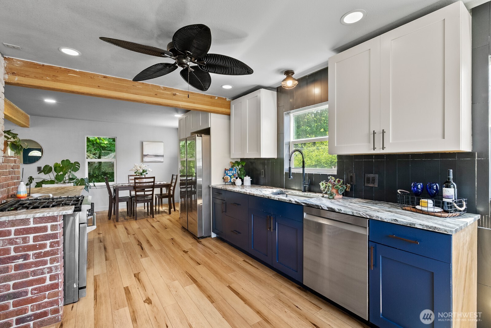 307 4th Street Steilacoom, WA 98388 - Photo 13 of 39 a kitchen with stainless steel appliances granite countertop a stove a sink dishwasher and a microwave oven with cabinets