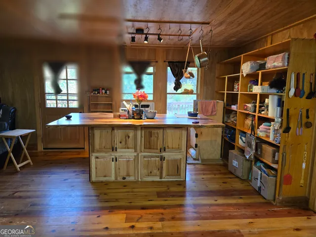 a kitchen with stainless steel appliances granite countertop a refrigerator a stove a sink and dishwasher with wooden floor