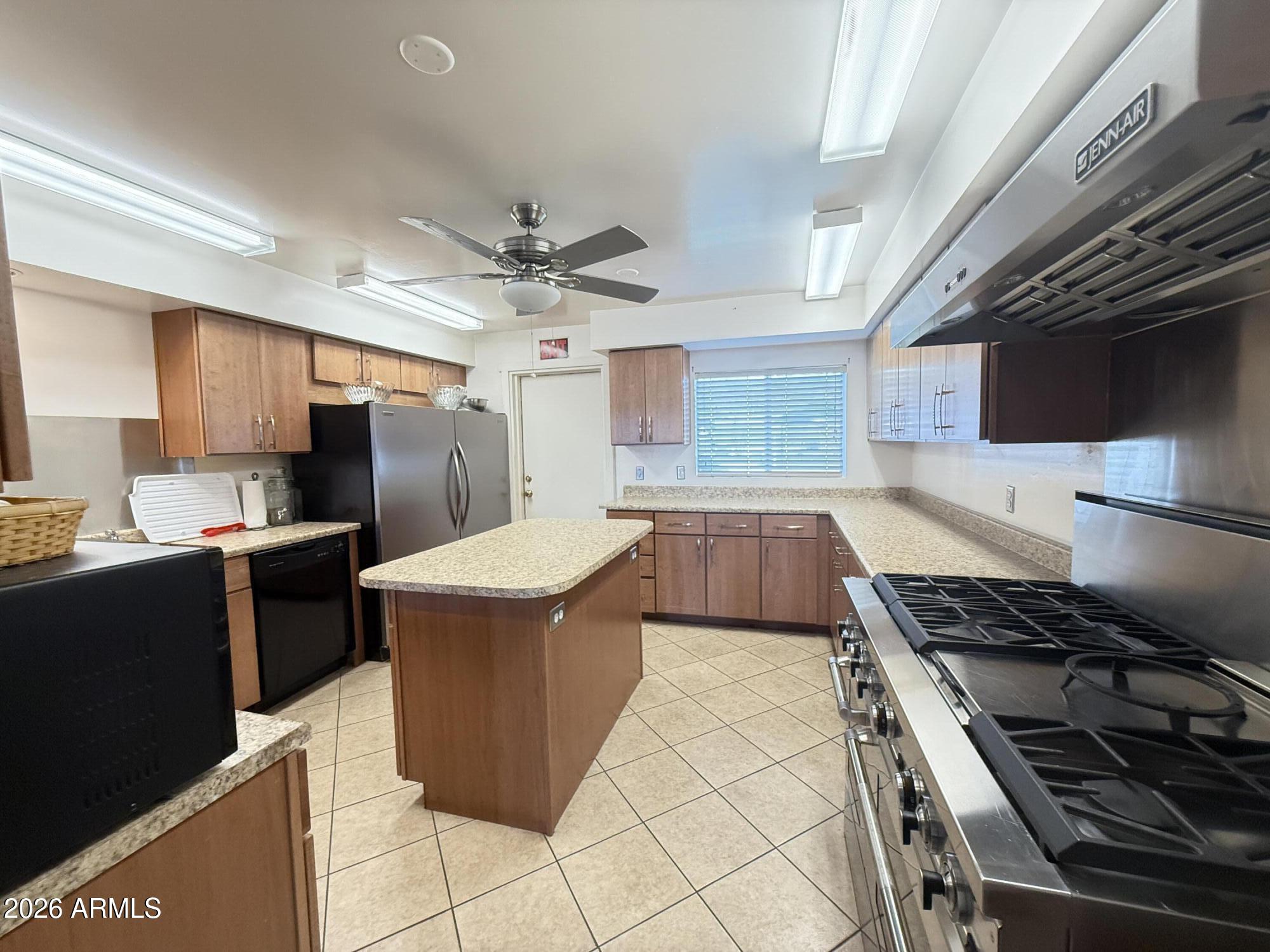 535 South Alma School Road, Unit 113 Mesa, AZ 85210 - Photo 31 of 41 a kitchen with stainless steel appliances granite countertop a stove a sink dishwasher and a refrigerator