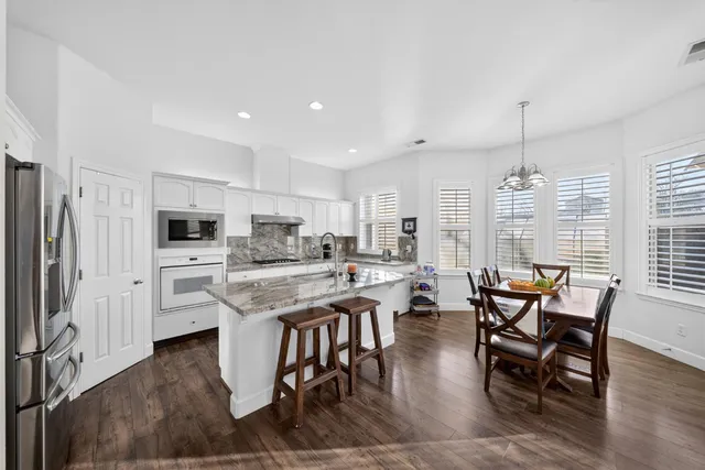 a kitchen with stainless steel appliances granite countertop a stove and a sink