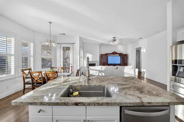a living room with furniture fireplace and a window