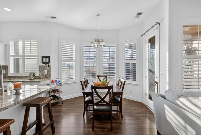a living room with furniture flat screen tv and wooden floor
