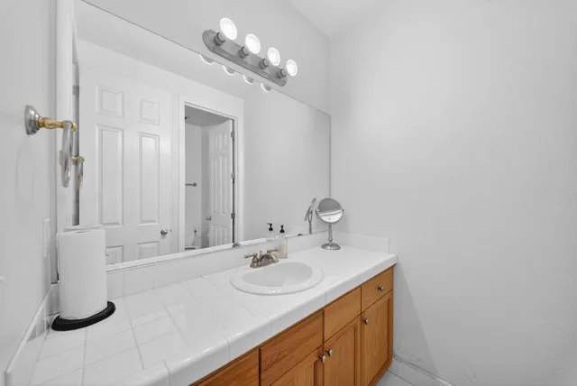 a view of a hallway with wooden floor and chandelier