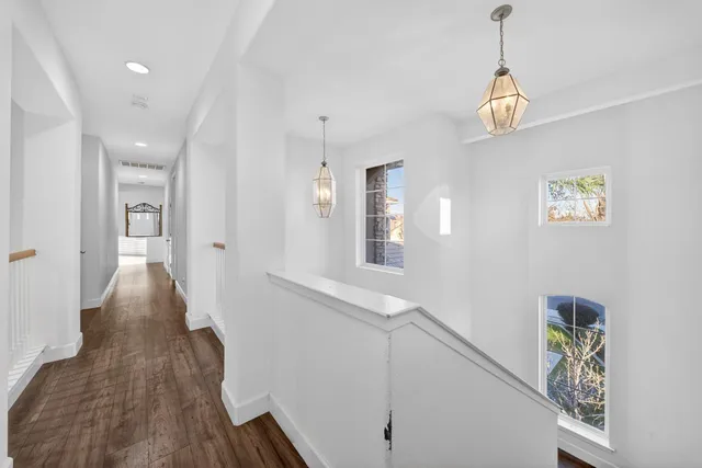 a view of empty room with wooden floor and windows
