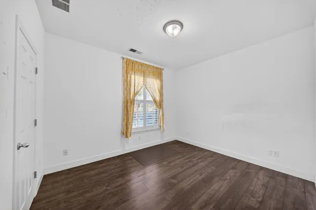 a bed room with a bed and wooden floor