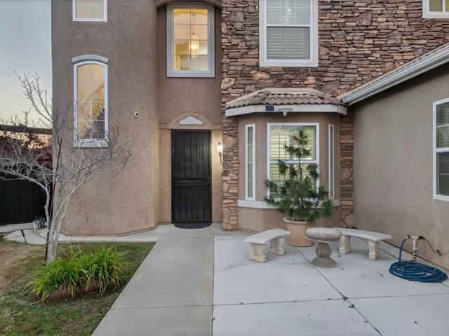 a view of a brick house with potted plants
