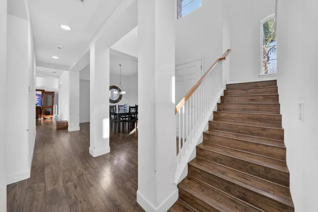 a view of entryway and hall with wooden floor
