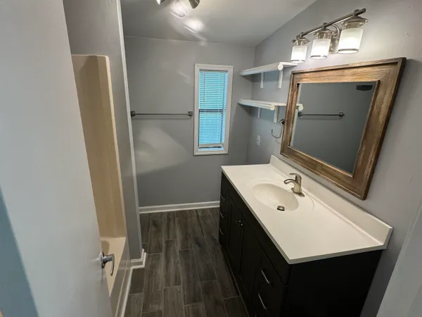 a bathroom with a sink a mirror and a toilet