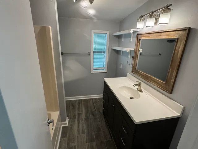 a bathroom with a sink a mirror and a toilet