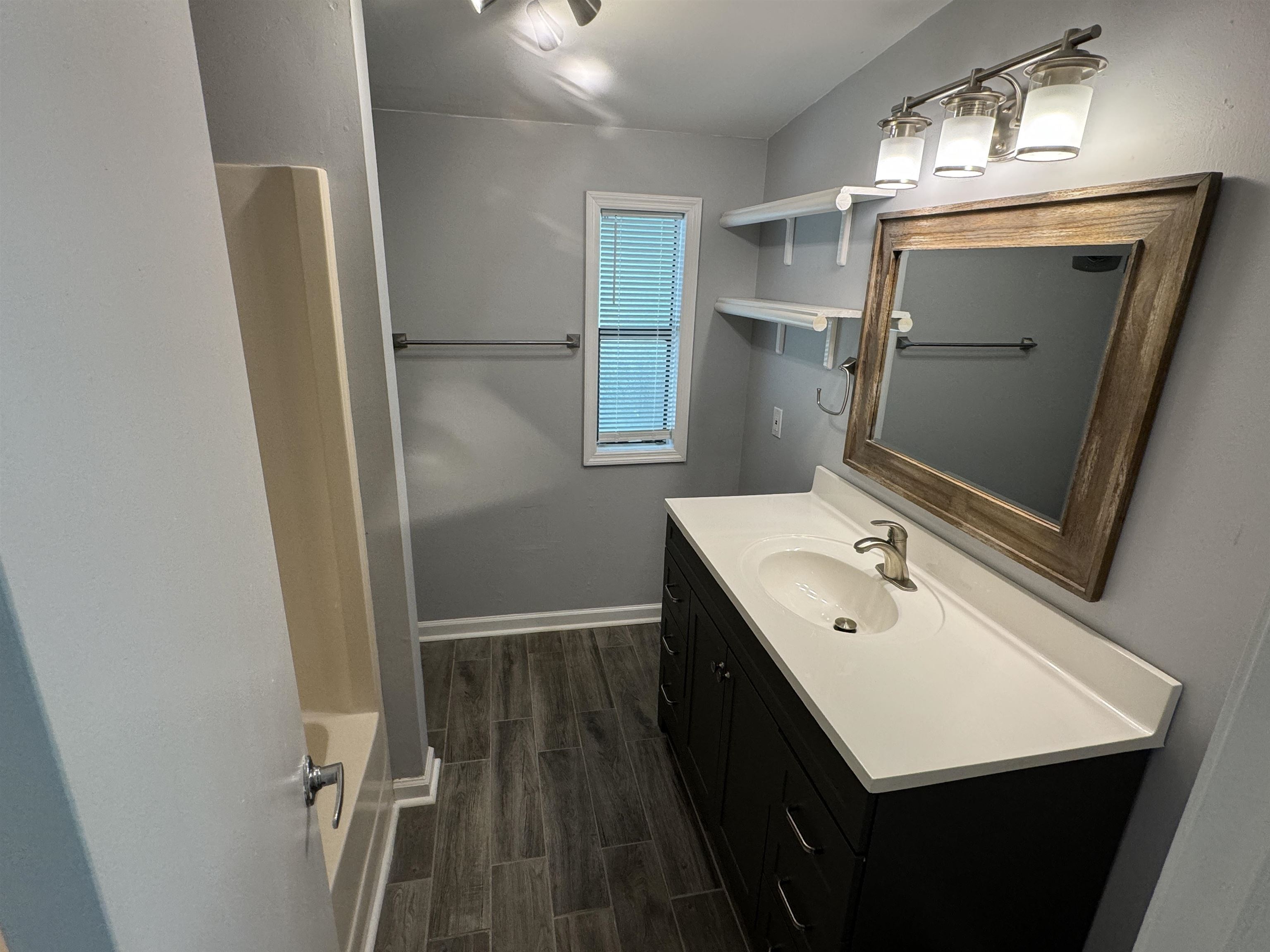 4430 Manucy Road, Unit C St. Augustine, FL 32084 - Photo 13 of 26 a bathroom with a sink a mirror and a toilet