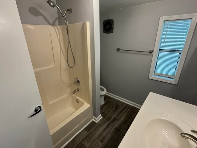 a bathroom with a bathtub and a shower