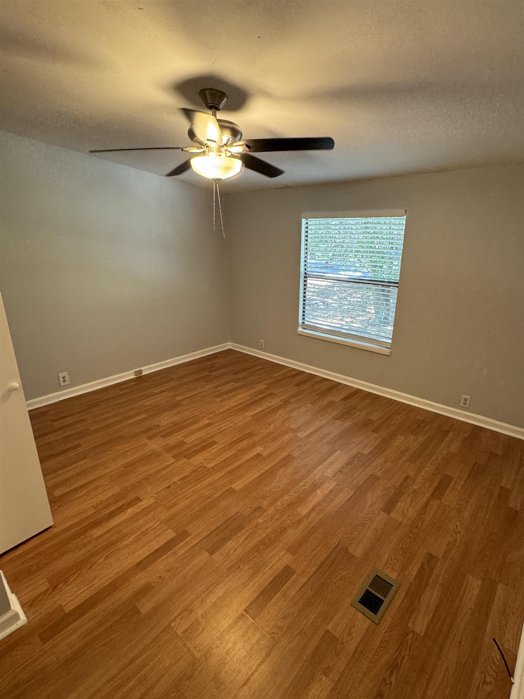 4430 Manucy Road, Unit C St. Augustine, FL 32084 - Photo 15 of 26 a view of a room with wooden floor and a ceiling fan