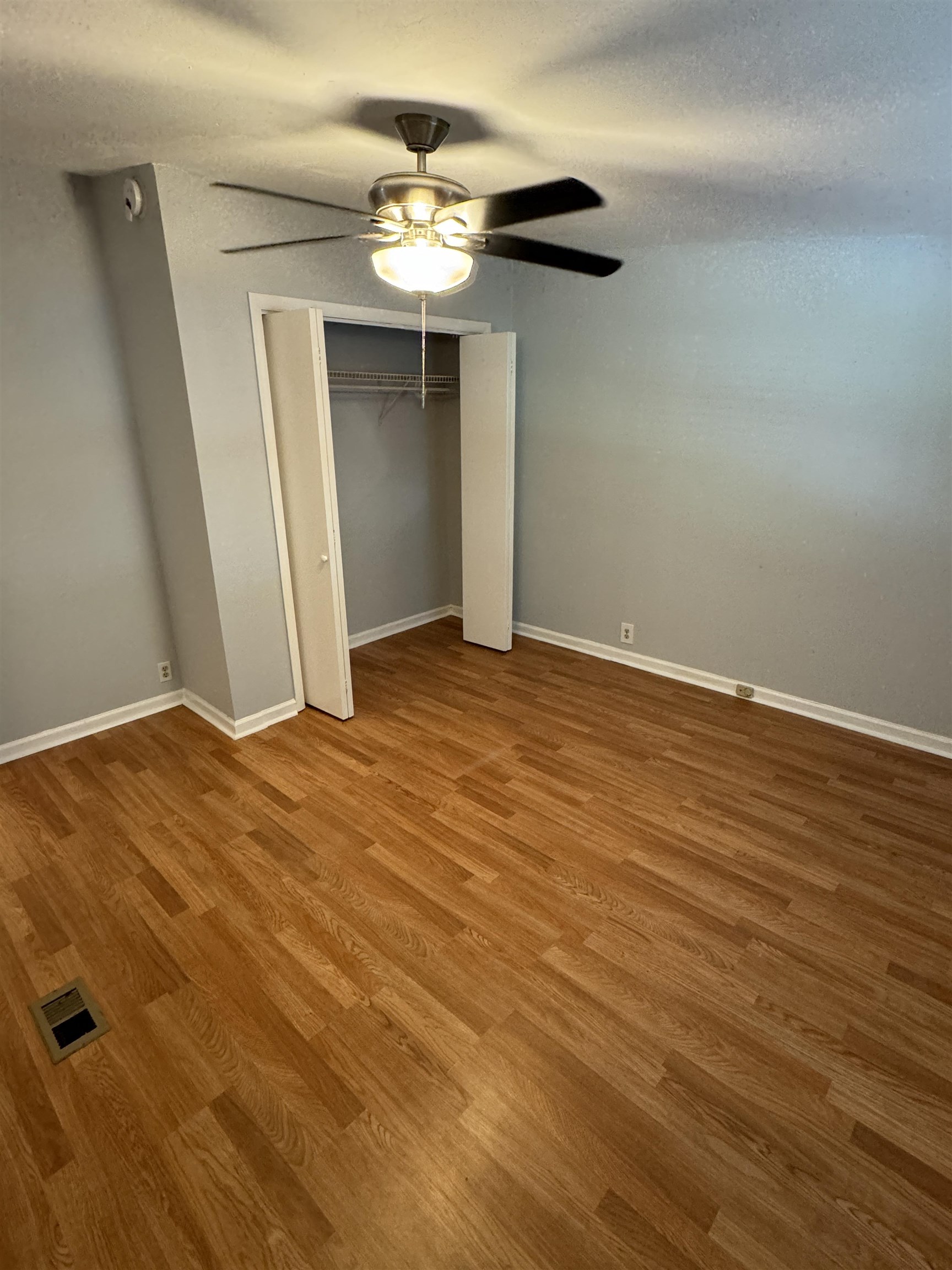 4430 Manucy Road, Unit C St. Augustine, FL 32084 - Photo 17 of 26 an empty room with wooden floor and chandelier fan