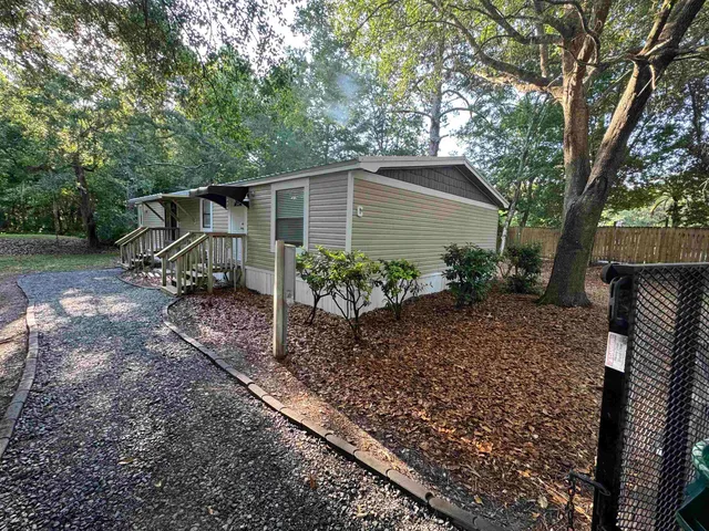 a backyard of a house with table and chairs